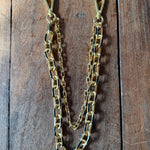 Gold chain on a wooden surface