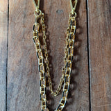 Gold chain on a wooden surface