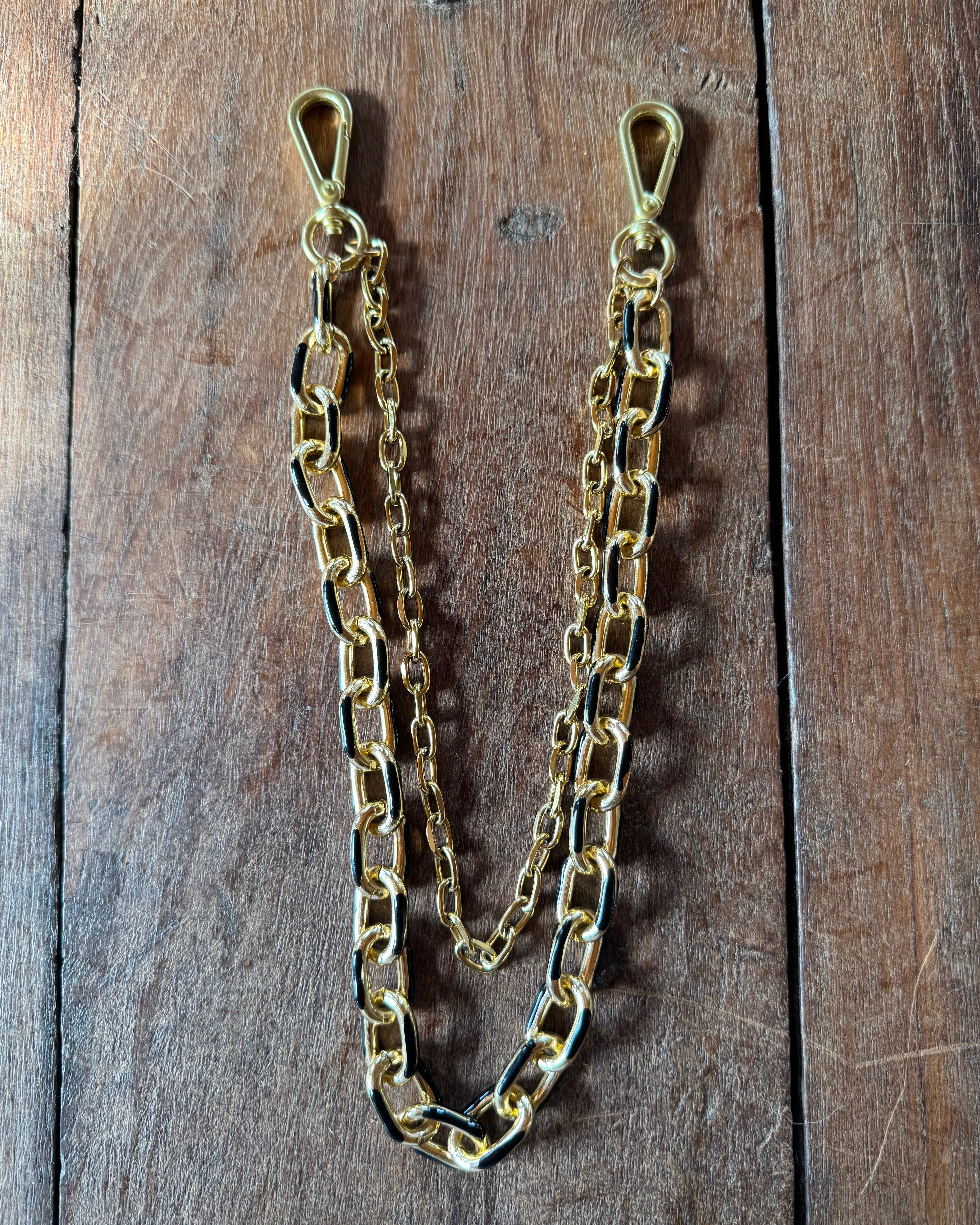 Gold chain on a wooden surface