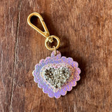 Decorative keychain with gemstone-like center on a wooden surface