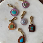 Set of decorative key chains on a marble plate with a wooden background