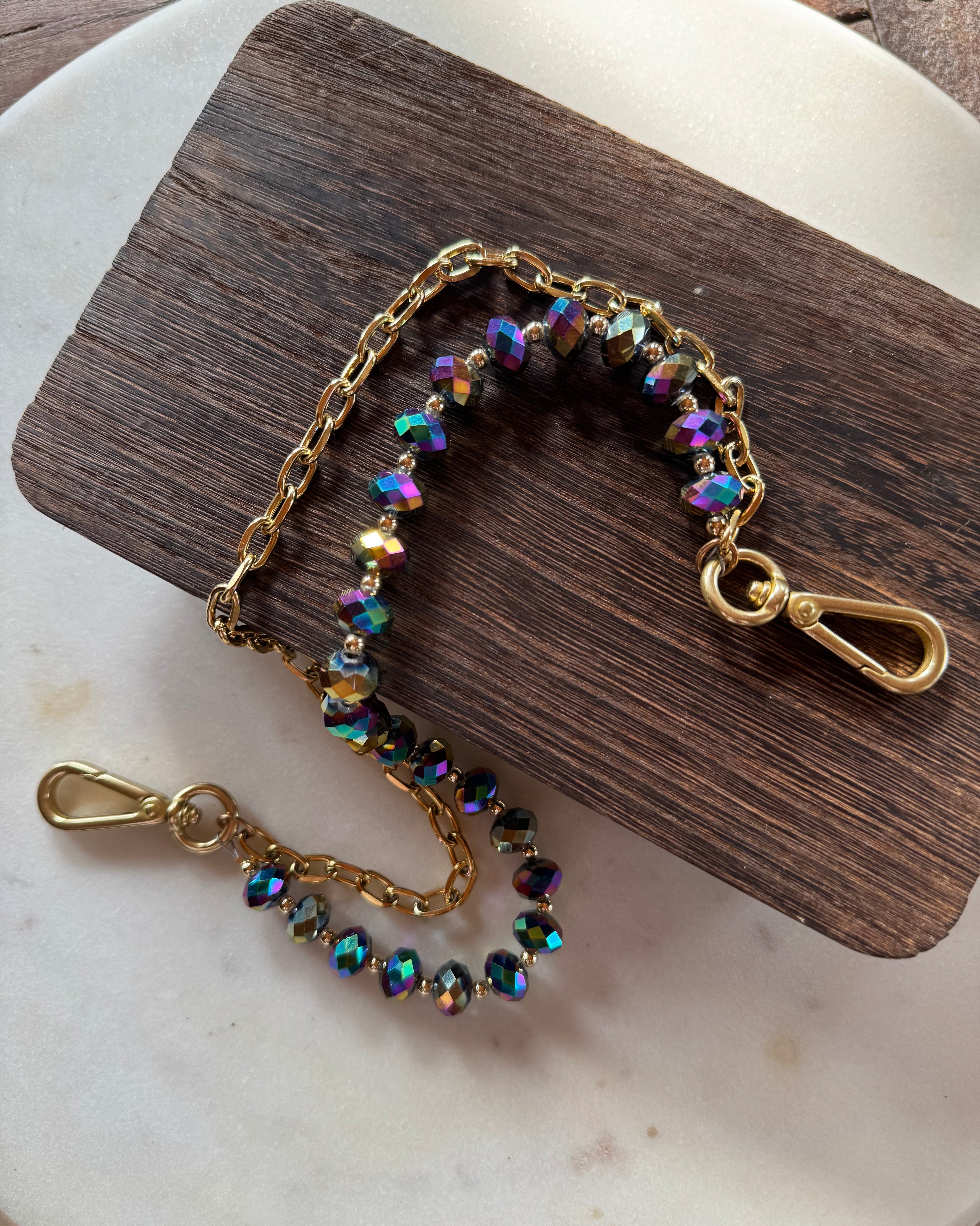 Jewelry with beads and chain on a wooden and marble surface