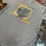 Gray t-shirt with a logo and text on a marble surface