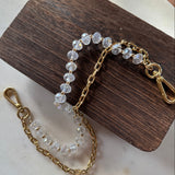 Close up shot of JForks & Leatherandvodka collab, crystal bead and gold chain as a handbag charm.