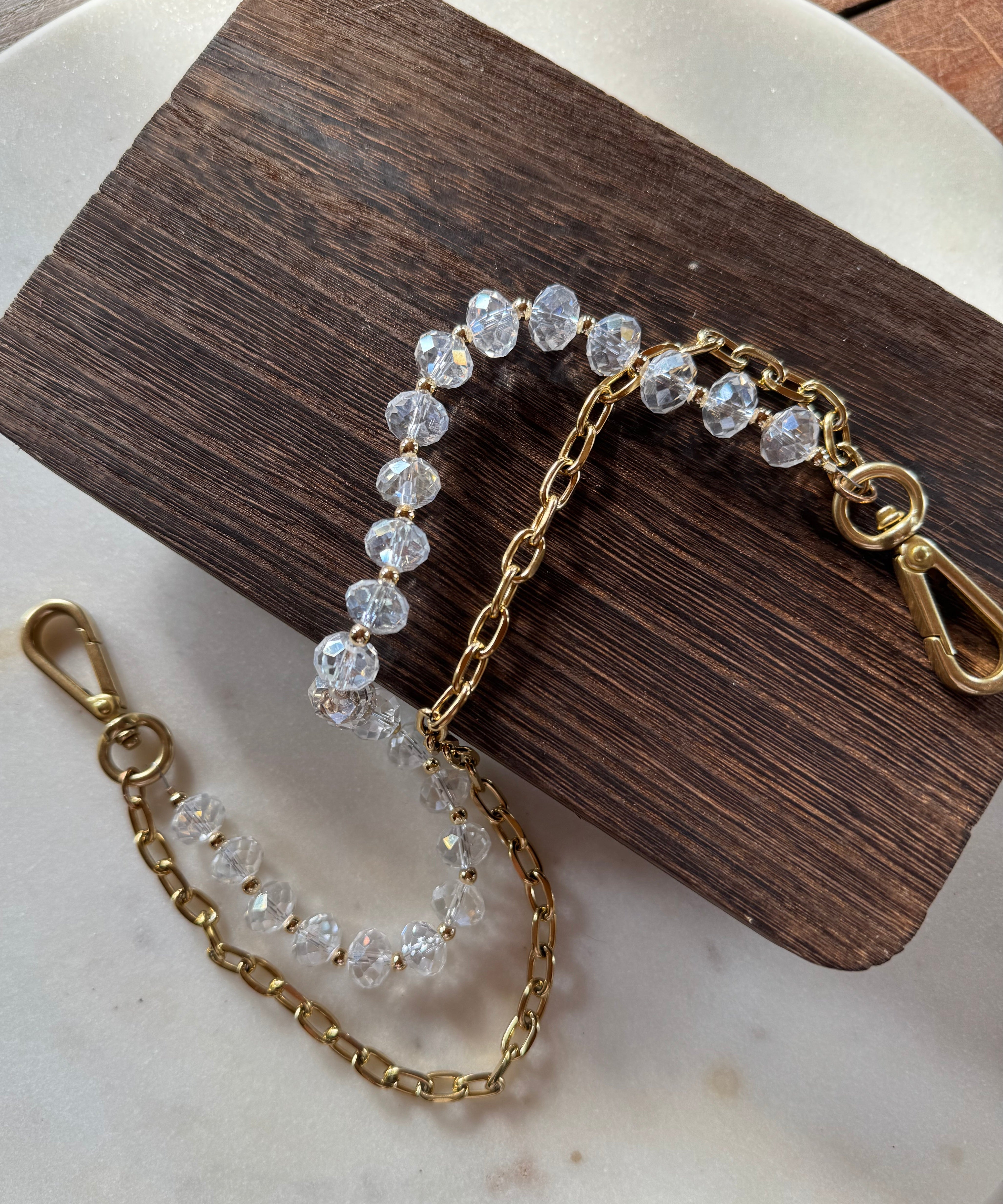 Close up shot of JForks & Leatherandvodka collab, crystal bead and gold chain as a handbag charm.