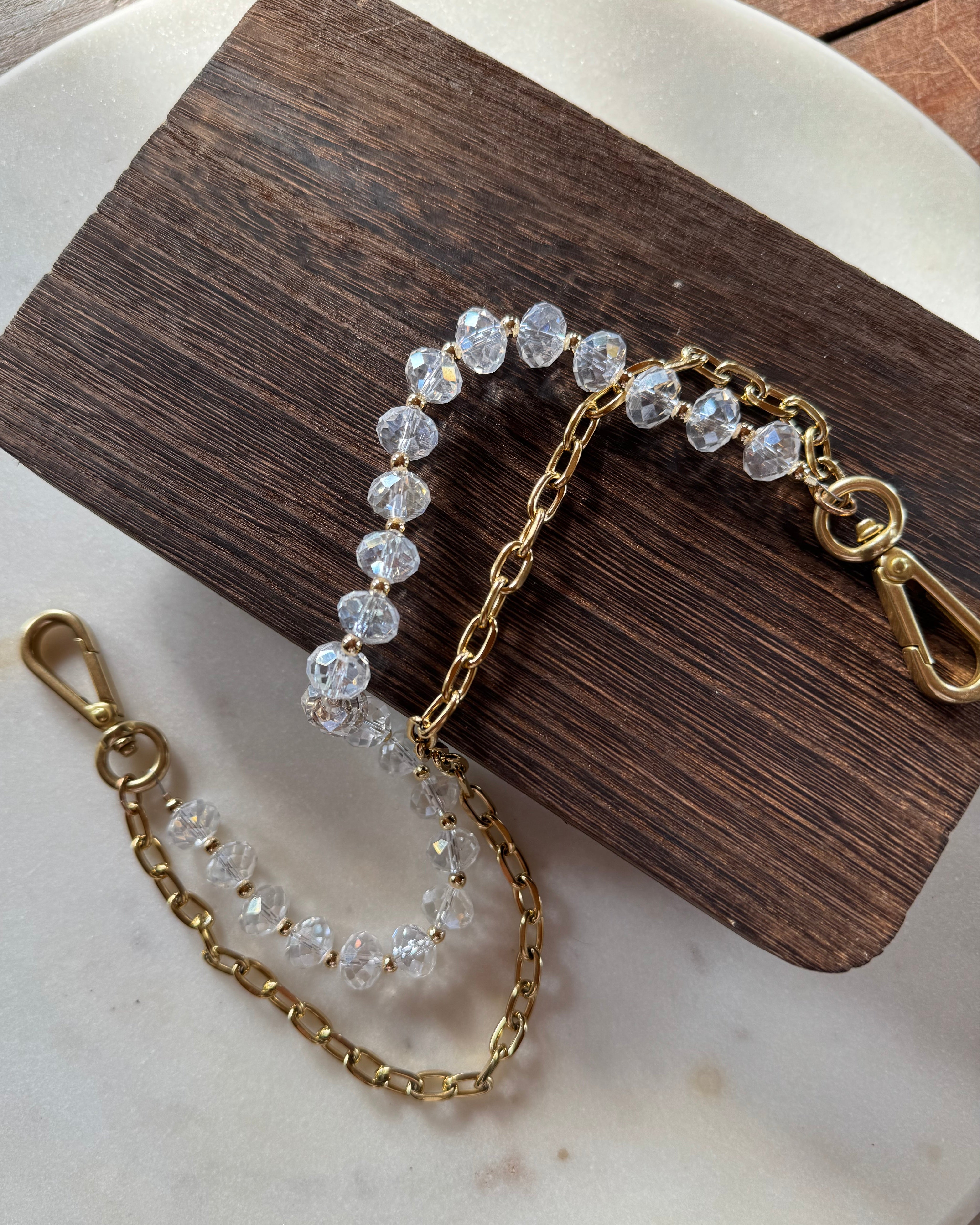 Close up shot of JForks & Leatherandvodka collab, crystal bead and gold chain as a handbag charm.