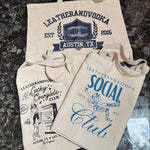 Three beige twill cotton tote bags with different limited edition designs and the 'Leatherandvodka' logo printed in blue.