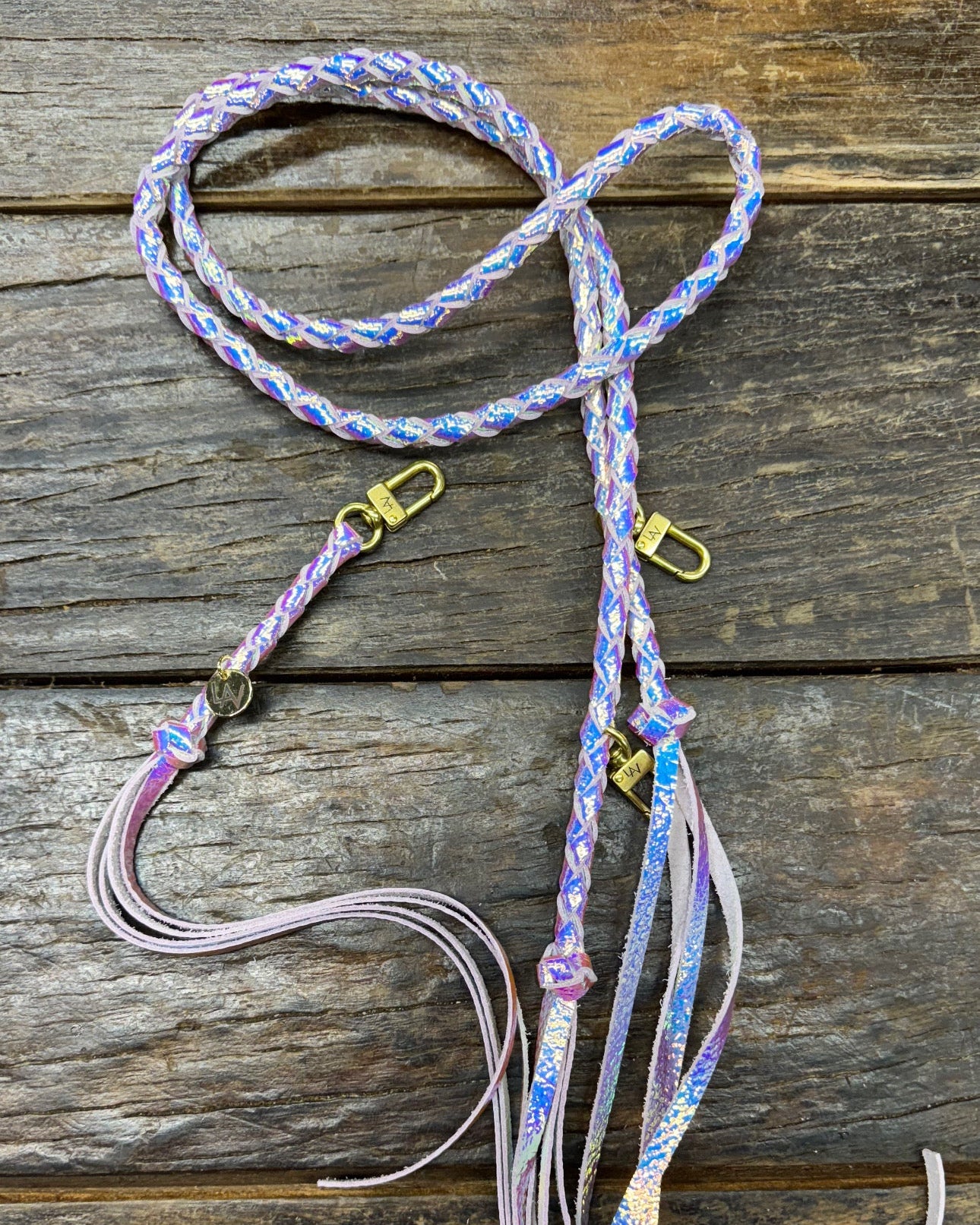 Iridescent Mermaid Bag Strap, made with braided leather with matching snap on key chain, laying on wooden table. 
