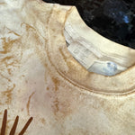 Close-up of a beige garment with a brand label and logo.
