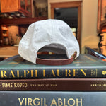 white baseball cap sitting on books in kitchen