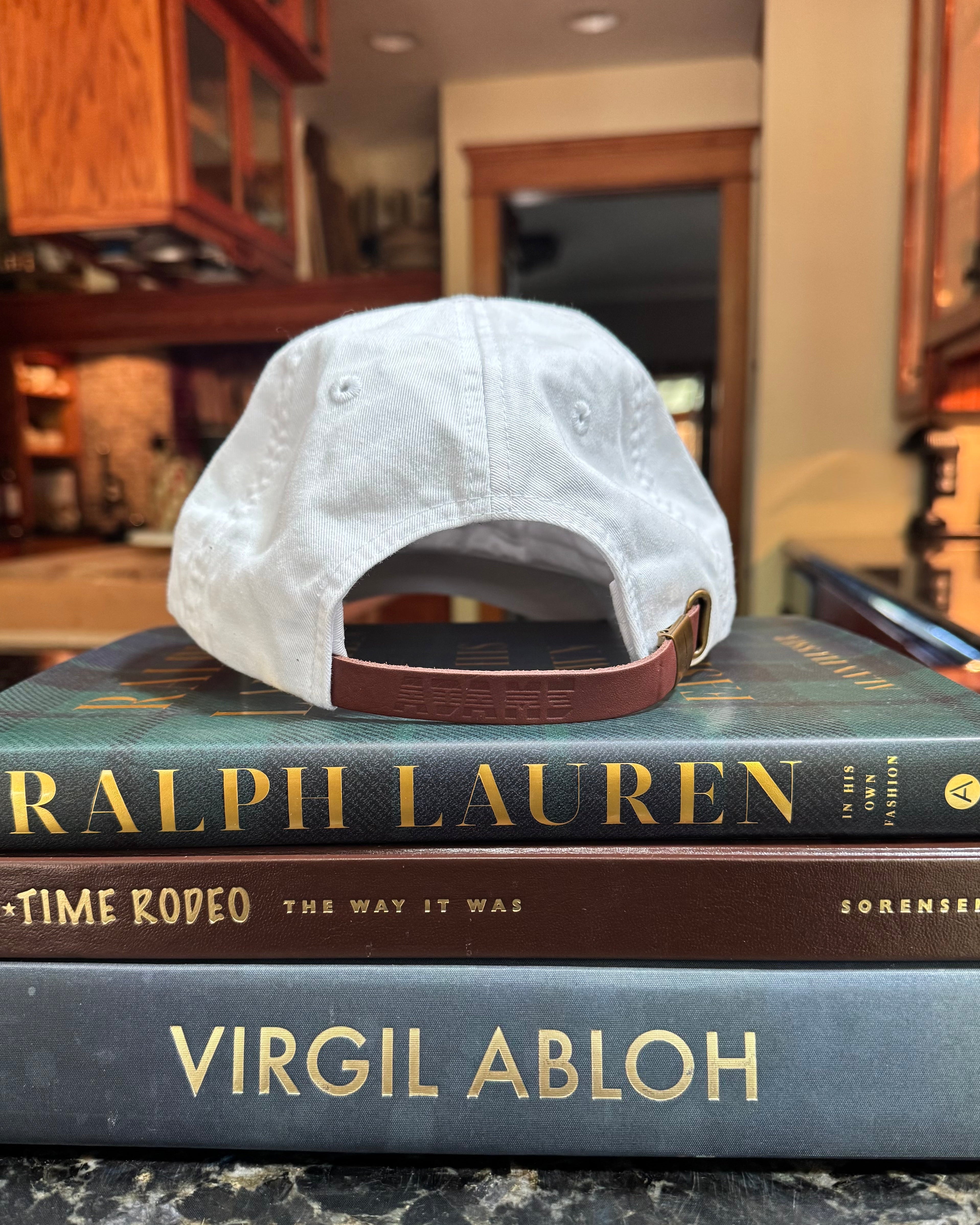 white baseball cap sitting on books in kitchen