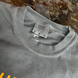 Gray t-shirt with a brand tag on a marble surface