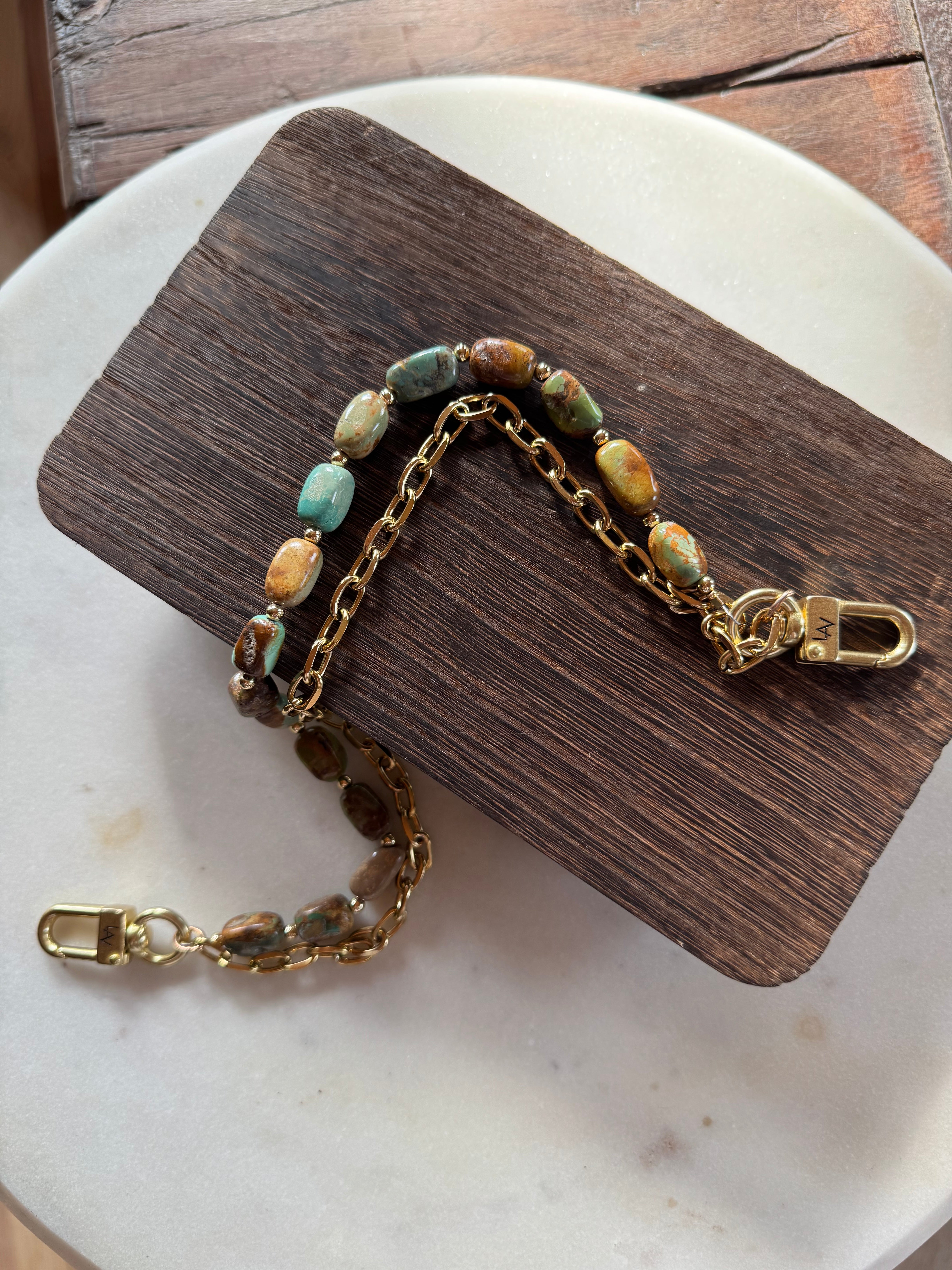 Gold handbag chain with embedded stones on a wooden block, Jforks, Leatherandvodka collaboration