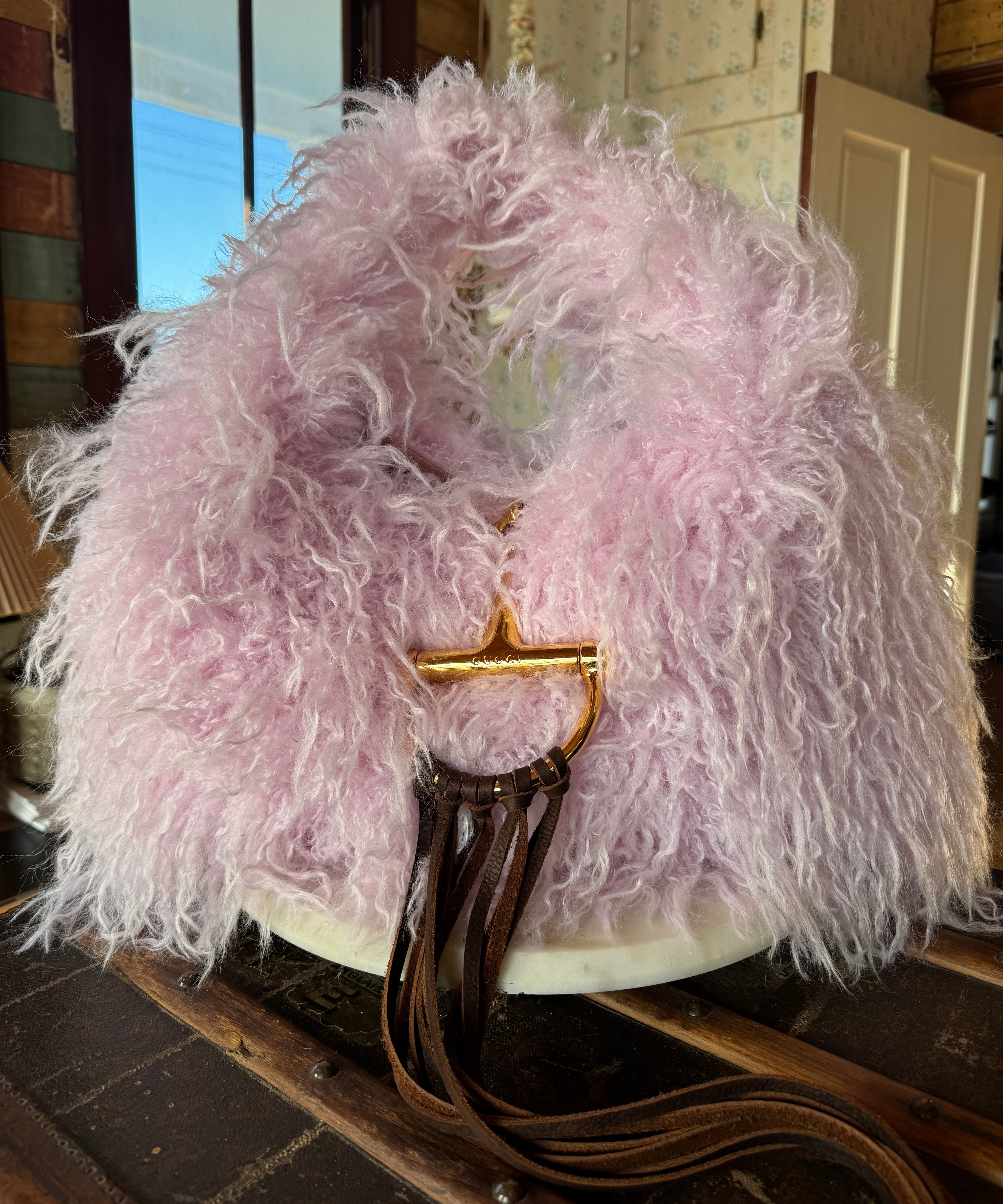Pink Gucci Softbit Shearling handbag with a gold clasp on a wooden surface with Leather finge. Leather and Vodka, LAV
