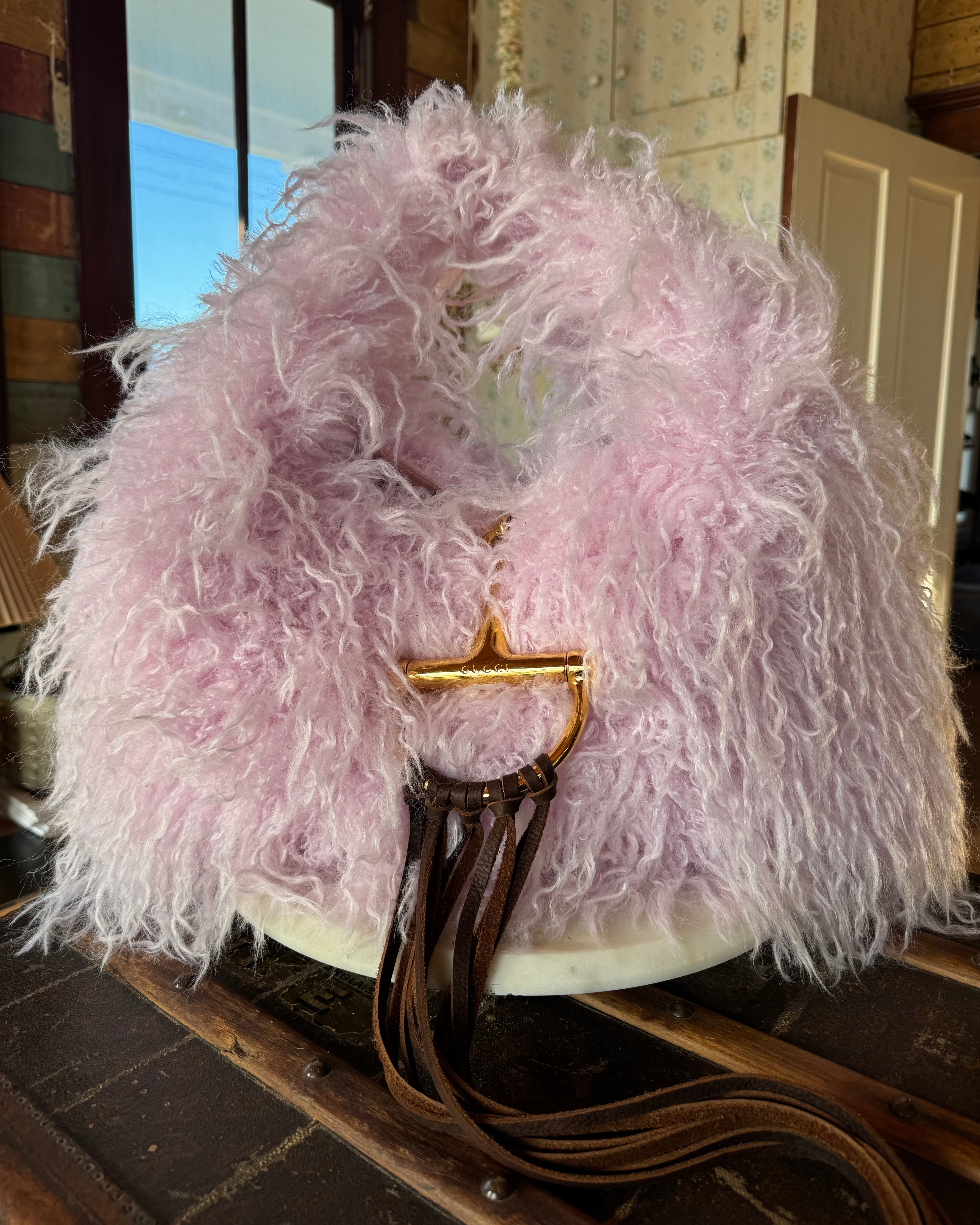 Pink Gucci Softbit Shearling handbag with a gold clasp on a wooden surface with Leather finge. Leather and Vodka, LAV