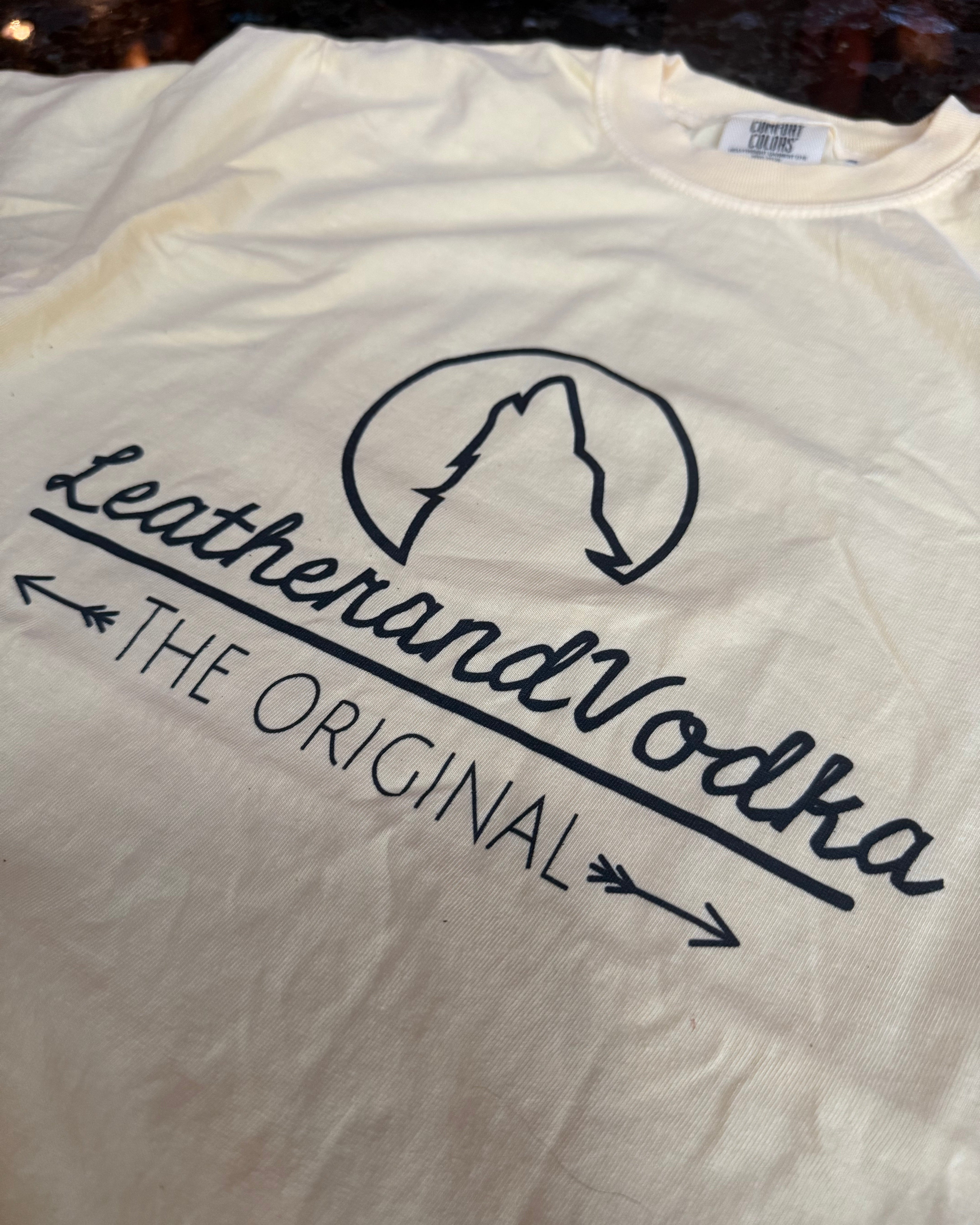 White sleeveless shirt with 'Leatherndvodka' logo and text on a white background