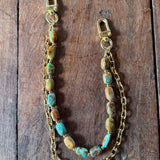 Gold handbag chain with embedded stones on a wooden block, Jforks, Leatherandvodka collaboration
