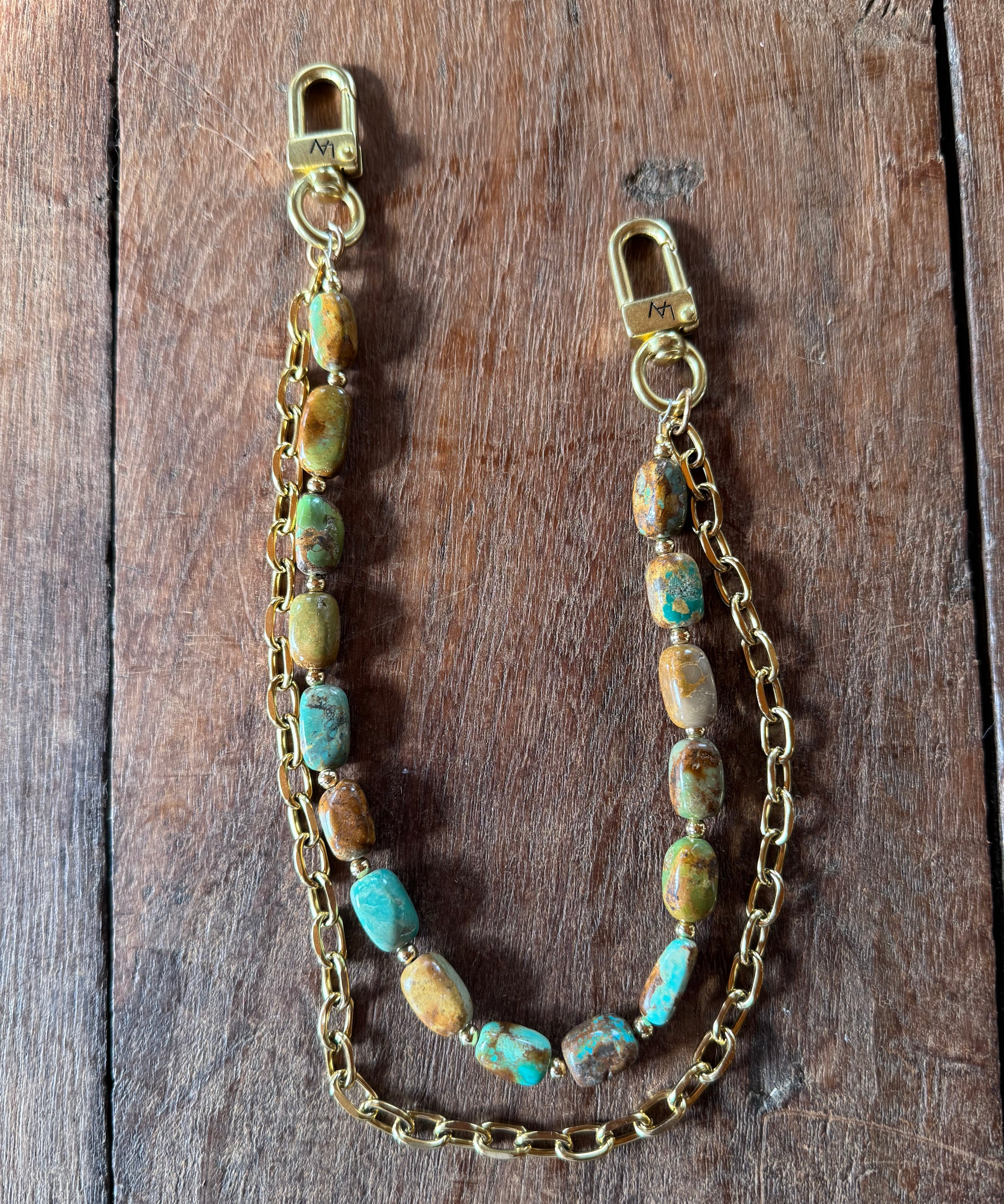 Gold handbag chain with embedded stones on a wooden block, Jforks, Leatherandvodka collaboration
