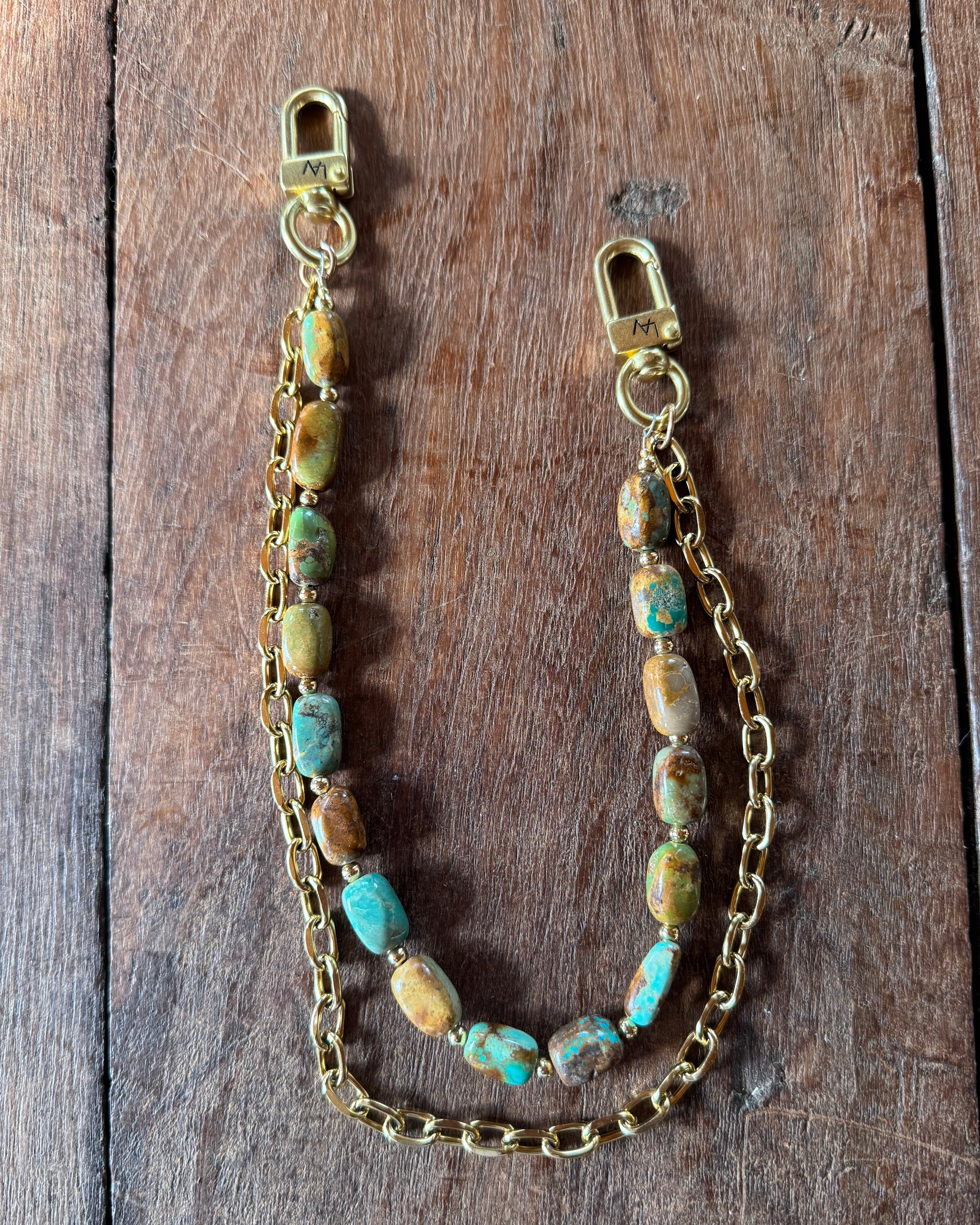 Gold handbag chain with embedded stones on a wooden block, Jforks, Leatherandvodka collaboration
