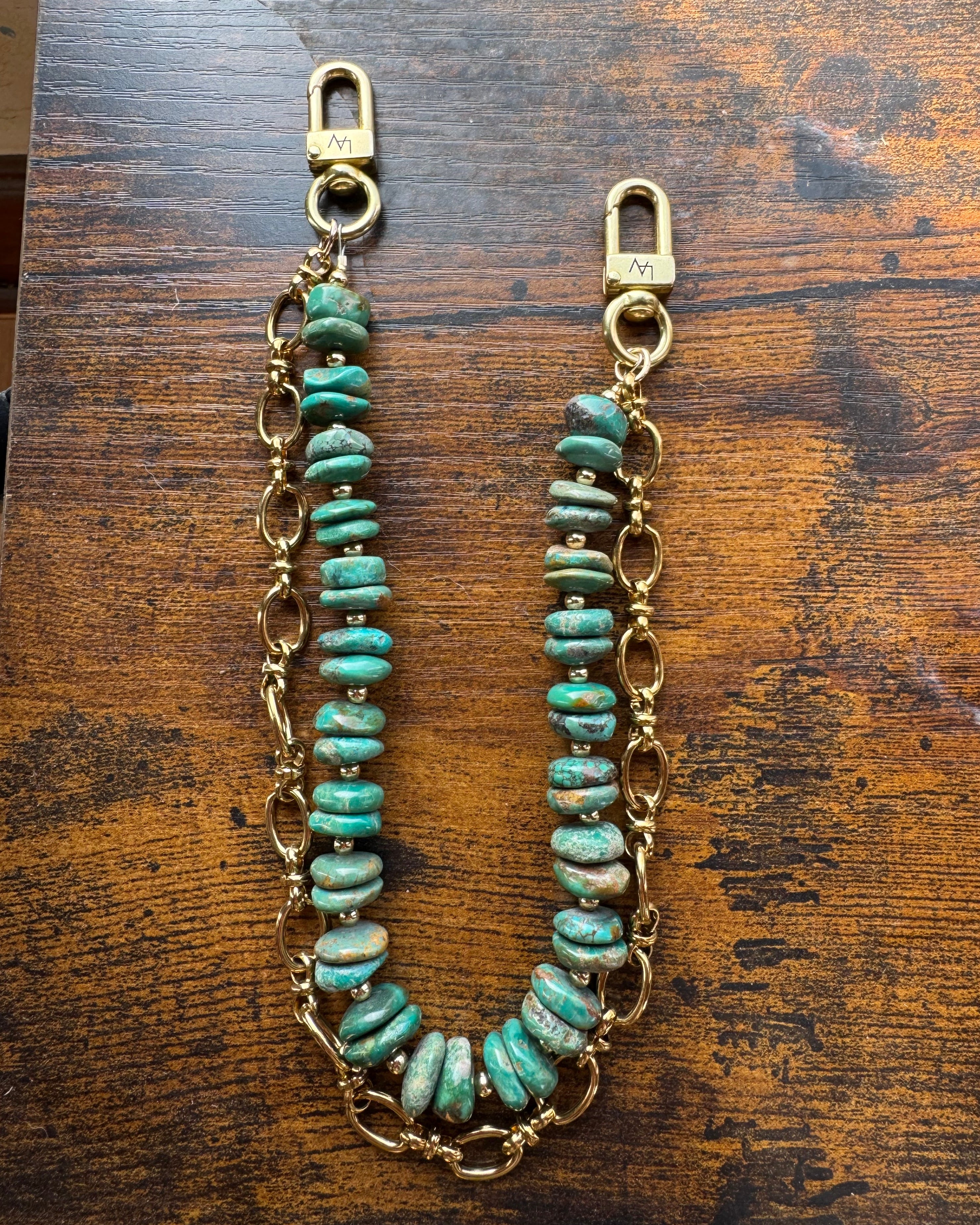 Turquoise beaded chain on a wooden surface, J Forks & Leather and Vodka