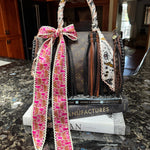 Handbag with a decorative strap on a marble surface