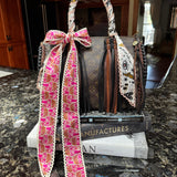 Handbag with a decorative strap on a marble surface